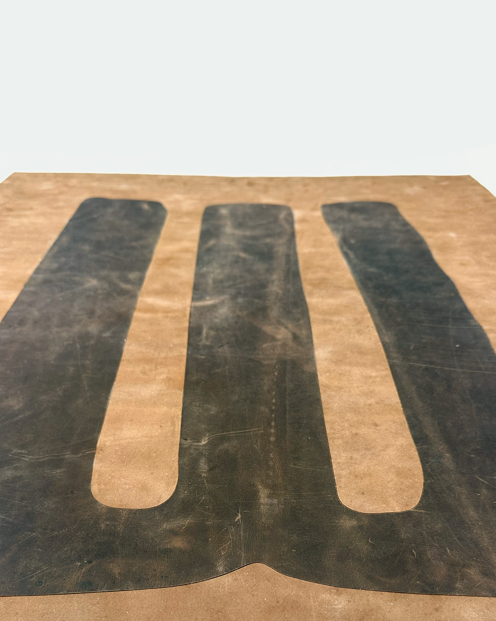Brown inlaid backgammon board with leather players, angled view