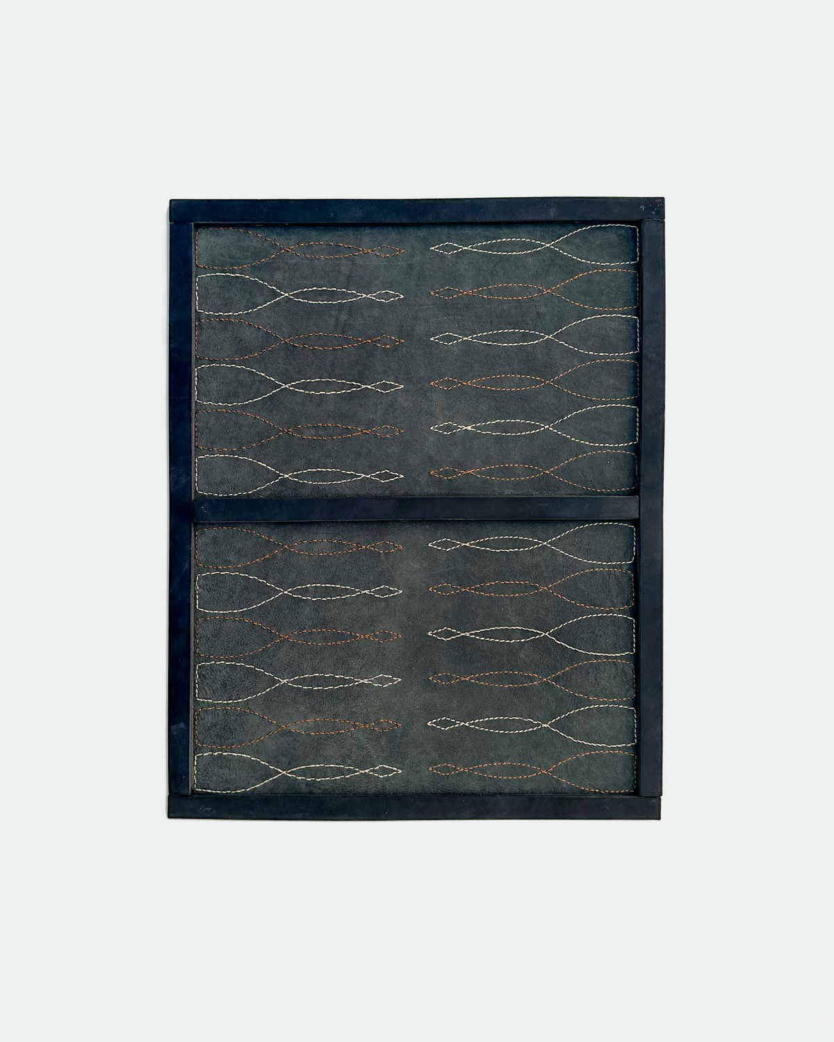Saddle stitch backgammon board in black leather with Havana cigar and cream stitched points