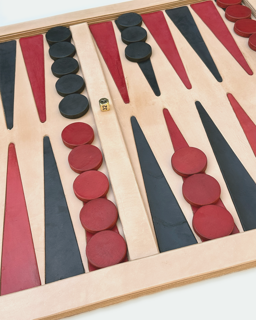 Natural veg-tan backgammon board set up for play, angled view